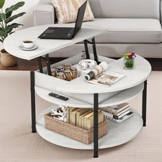 a living room with a couch, coffee table and laptop on top of the table