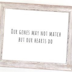 a white frame with the words our genees may not match but our hearts do