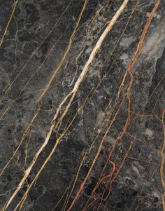 the marble is black and brown with white streaks on it's edges, as well as thin yellow vines