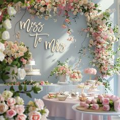 a table topped with lots of flowers next to a sign that says miss to mrs