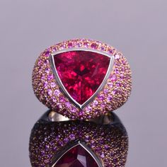 A gorgeous 12.21 carat trillion cut rubellite that is surrounded by an ombre of diamonds and pink sapphires. Made of 5.65 carats of delicate pink sapphires and 1.80 carats of white diamonds, all are set in 18k white and rose gold. This statement ring is very unique and a real eye catcher! Cocktail Rings Statement, Mens Rings Fashion, Diamond Cluster Engagement Ring, Sparkly Jewelry, Fine Ring, Cluster Engagement Ring, Ring With Diamond, Domed Ring, Jewelry Manufacturers