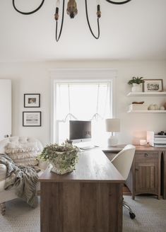 a living room filled with furniture and a flat screen tv sitting on top of a wooden table