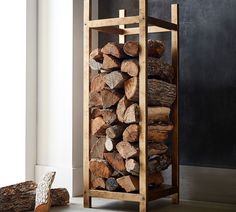 a stack of logs sitting next to a pile of wood on top of a floor