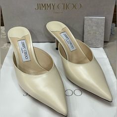 Elevate Your Shoe Game With These Stunning Jimmy Choo Rav 65mm Mules In Chalky White “Liquid” Leather. The Sleek Pointed Toe And Classic Slip-On Mule Design Make These Heels A Must Have For Any Fashion-Forward Woman. The Mid-Height Stiletto Heel Is Both Stylish And Comfortable, Perfect For A Day-To-Night Transition. These Shoes Come Brand New In Their Box With The Dust Bag, Ready To Elevate Any Outfit With Their Timeless Design. Please Review All Photos, Which Are A Part Of The Description. Happ Luxury Slip-on Heels With Heel Strap, Designer Kitten Heels With Pointed Toe, Calf Leather Kitten Heels With Branded Heel Counter, Luxury Leather Open Heel Kitten Heels, Luxury Leather Kitten Heels With Open Heel, Luxury Leather Kitten Heels With Open Back, Designer Kitten Heels With Branded Heel Counter, Luxury Calf Leather Slingback Kitten Heels, Classic Open Heel Kitten Heels In Calf Leather