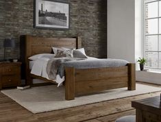 a bedroom with a brick wall and wooden furniture in the room, including a bed