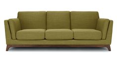 a green couch sitting on top of a wooden frame