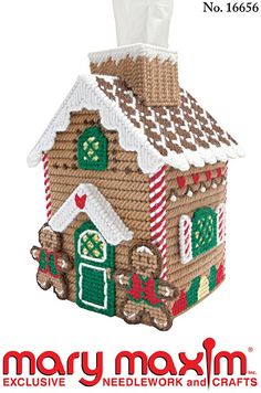 an ornament made to look like a house with gingerbreads on it