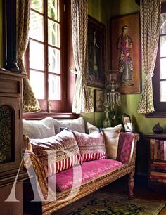 a living room filled with lots of furniture and windows