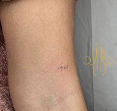 a woman's lower arm with the word peace tattooed on her left side ribcage