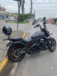 a motorcycle is parked on the side of the road in front of a street light