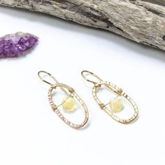 Fiery Ethiopian opal gemstones swing and shimmer at the core of these hand forged 14k gold filled oval earrings. From our Wanderlust Collection. #goldaccessories #minimaliststyle #opalaccents •14k gold filled •Ethiopian opal •Dimensions: 1/2 x 1 3/8" Oval Opal Earrings In Yellow Gold, Yellow Gold Oval Opal Earrings, Handmade Oval 14k Gold Filled Earrings, Gold Ethiopian Opal Earrings For Gift, 14k Gold Filled Oval Earrings With Ear Wire, Oval 14k Gold-filled Earrings With Ear Wire, Oval Earrings, Oval Earring, Jewelry Repair