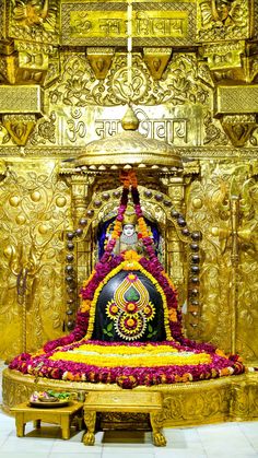 an elaborately decorated shrine with flowers on the floor