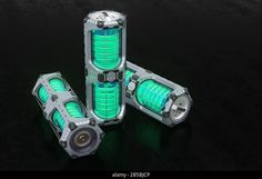 three futuristic green and silver objects on black background