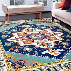 a living room area with couches and rugs