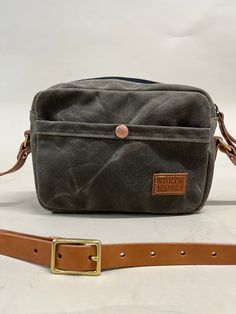 Our smallest crossbody. Built with structure, durability, and a lifetime of use. Designed with one exterior pocket to store your phone on the go and one interior pocket to organize all necessities. Black On Black, Waxed Canvas, Small Crossbody, Vegetable Tanned Leather, Brass Hardware, New Bag, Natural Leather, Tan Leather, Solid Brass