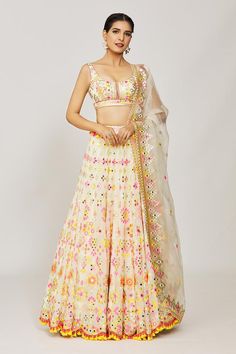 Multi color georgette flared lehenga crafted with attached can-can, all over floral, geometric pattern, multi color thread, mirror and sequin embroidery. Paired with embroidered padded blouse and embroidered dupatta.
Components: 3
Pattern: Embroidered and Printed
Type Of Work: Thread, Mirror and Sequin Work
Neckline: Round Neck
Sleeve Type: Sleeveless
Fabric: Georgette, Dupatta: Organza
Color: Multi Color
Other Details: 
Fringe drop tasselled lehenga border
Deep round back
Scalloped cut work hem Off White Georgette Lehenga For Festivals, White Georgette Lehenga With Dori Work, Off White Georgette Choli With Resham Embroidery, Off White Georgette Lehenga With Zari Work, Festive Off White Georgette Choli, Festive Off-white Georgette Choli, Off White Lehenga For Navratri, Gopi Vaid, Flared Lehenga