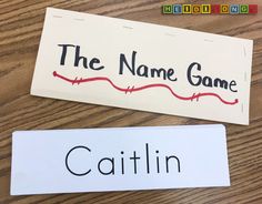 two name tags on a wooden table that say the name game and the name catlin