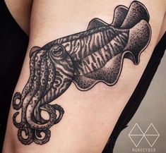 an octopus tattoo on the side of a woman's thigh with words written underneath it