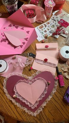 many different types of valentine's day cards on a table with pink and red decorations