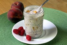 there is a bowl of oatmeal and some raspberries on the plate