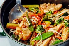 a stir fry with chicken, broccoli, and rice in a skillet