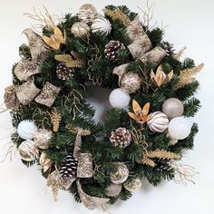 Embrace the elegance of a neutral Christmas with this stunning 20" gold and white wreath. Crafted on a bed of lush pine greenery, this wreath features a sophisticated blend of shimmering gold accents and frosty white details. Imagine this eye-catching wreath gracing your front door, welcoming guests with its understated charm. The neutral color palette complements any decor style, from classic to modern farmhouse, making it a versatile addition to your holiday home. Key Features: Timeless Design: The gold and white color scheme offers a sophisticated twist on traditional Christmas decor. Versatile Decor: Perfect for your front door, mantel, or as a statement piece above a console table. High-Quality Materials: Crafted with durable and lifelike pine greenery for lasting enjoyment. Generous Neutral Christmas Wreath, Gold And White Color Scheme, Christmas Wreath Gold, Neutral Holiday Decor, Traditional Christmas Decor, Christmas Decorations Office, White Christmas Wreath, Traditional Christmas Decorations, Neutral Christmas