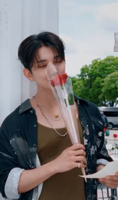 a woman holding a bouquet of flowers in front of her face