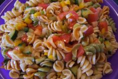 a purple plate topped with pasta and vegetables