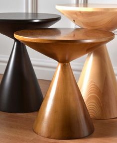 three wooden stools sitting next to each other on top of a hard wood floor