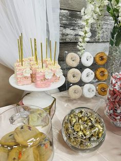 an assortment of pastries and desserts on display at a wedding or baby shower