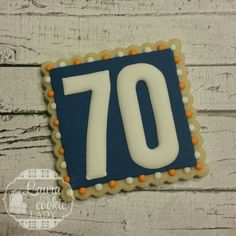 a decorated cookie with the number seventy on it