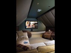 a home theater in the corner of a room with two couches and a flat screen tv