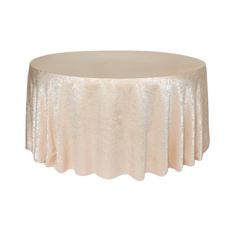 a round table with a white cloth on the top and an off - white background