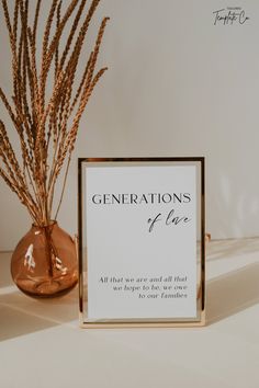 there is a sign that says generations of love next to a vase with some dry grass in it