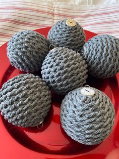 several balls of yarn sitting on top of a red plate