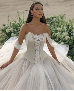 a woman in a wedding dress sitting on a table