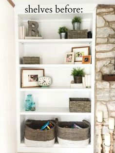 a white book shelf with baskets and pictures on it