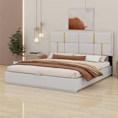 a white bed sitting on top of a hard wood floor