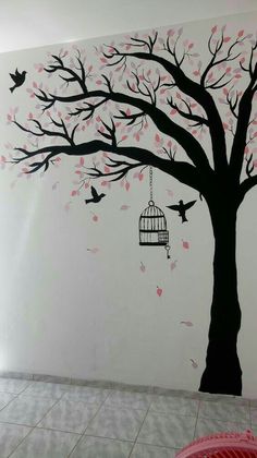 a tree with birds flying around and a birdcage hanging from it