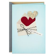 a card with a envelope and two hearts on the front, tied in twine