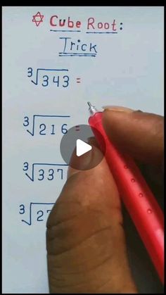 a person holding a pen and writing on a piece of paper with numbers in it