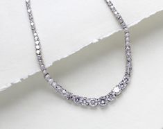 Beautiful rose gold cubic zirconia bridal tennis necklace created with Round cubic zirconia in a graduated style. This is classic style that will match any wedding gown or special occasion dress - PLEASE ALLOW APPROX 3-5 BUSINESS DAYS FOR COMPLETION BEFORE SHIPPING.- Handcrafted with Premium cubic zirconia stones - All clear stones- Rhodium, yellow gold or rose gold finish- Necklace measures 16.5 inches and extends to 18.5 inches- Nickel free and hypoallergenic This is an original design by © Treasures by Agnes FOR MATCHING PIECES SIMPLY TYPE "SOPHIE" IN THE SEARCH BAR Wedding Tennis Necklace With Brilliant Round Cut, Brilliant Cut Tennis Necklace For Wedding, Single Strand Round Tennis Necklace For Wedding, Single Strand Tennis Necklace For Wedding, Wedding Tennis Necklace With Brilliant Cut Cubic Zirconia, Brilliant Cut Cubic Zirconia Tennis Necklace For Wedding, Wedding Cubic Zirconia Single Strand Tennis Necklace, Wedding Tennis Necklace With Single Strand Cubic Zirconia, White Gold Tennis Necklace With Sparkling Stones For Wedding