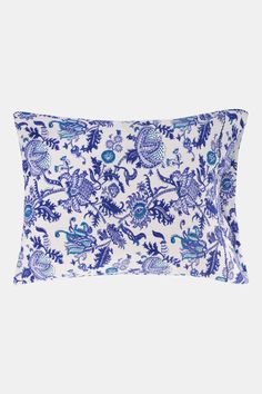 a blue and white pillow with an ornate pattern