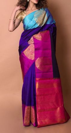 a woman in a purple and blue sari