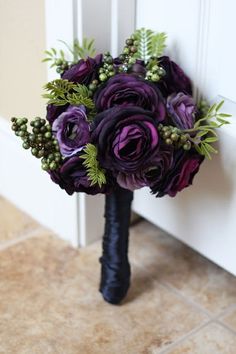 a purple wedding bouquet sitting on top of a door