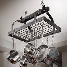 pots and pans are hanging from the ceiling