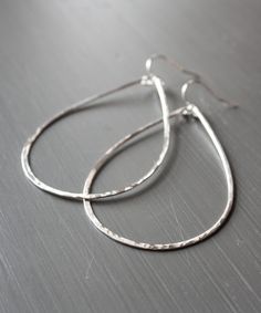 "Hammered and formed by hand, our Olivia Teardrop Earrings come with extra shimmer and in a size for everyone. This large 2.5\" size is one of Heather's Top Picks that everyone should own - they are lightweight, sturdy for travel, and a modern update to the basic hoop. To ensure the longevity of this design, all elements are made from high quality 14k Gold Filled or Sterling Silver wire that is hypoallergenic and will not flake, discolor or wear off over time. Looking for a different size? The O Boho Hoop Earrings, Board Room, Hammered Hoop Earrings, Gold Filled Hoops, Natural Stone Jewelry, Crystal Stud Earrings, Big Earrings, Large Earrings, Gold Filled Jewelry