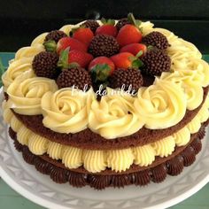 a chocolate cake with white frosting and strawberries on top