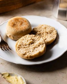 three biscuits on a plate with a fork