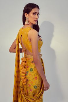 Yellow pre-draped saree with floral printed motifs and attached pallu. Comes with embroidered blouse and belt.
Component: 3
Pattern: Print, Embroidery
Type Of Work: Floral Print, Dori and Sequin Work
Neckline: Round
Sleeve Type: Sleeveless
Fabric: Dupion Silk
Color: Yellow
Other Details: 
Keyhole front
Blouse with thread and sequin work
Low back with tie up and tassels
Sequin embellished belt
Occasion: Wedding - Aza Fashions Saree Blouse Back Designs, Latest Saree Blouse, Sleeveless Blouse Designs, Blouse Back Neck, Lehenga Blouse Designs, Blouse Back Neck Designs, Blouse Back, Cinderella Wedding, Back Neck Designs